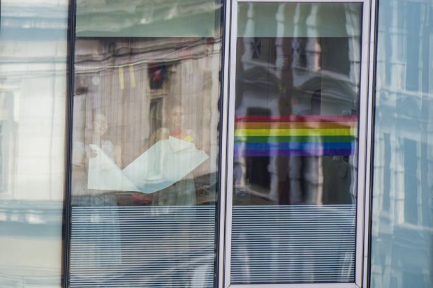 Sonia and Liv putting up rainbow stickers on windows