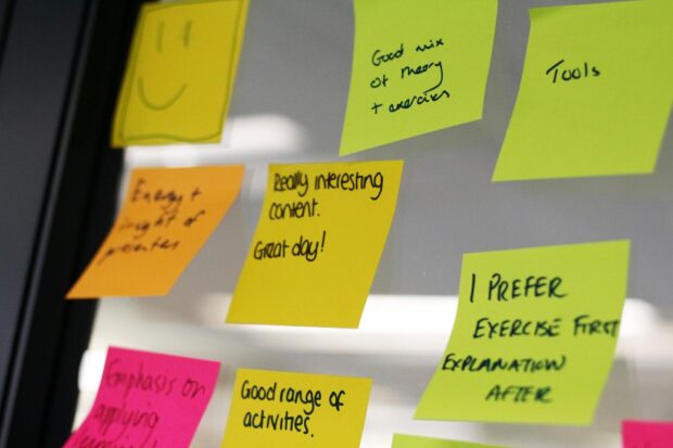 Post-it notes on a wall showing feedback including 'really interesting content - great day!'