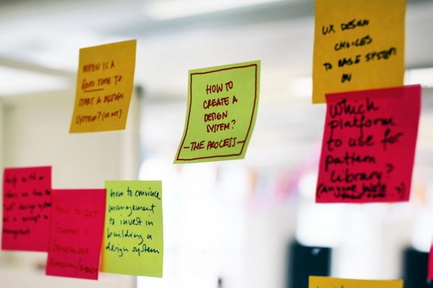 A series of Post-it notes - one of which reads: 'How to create a design system?' - process