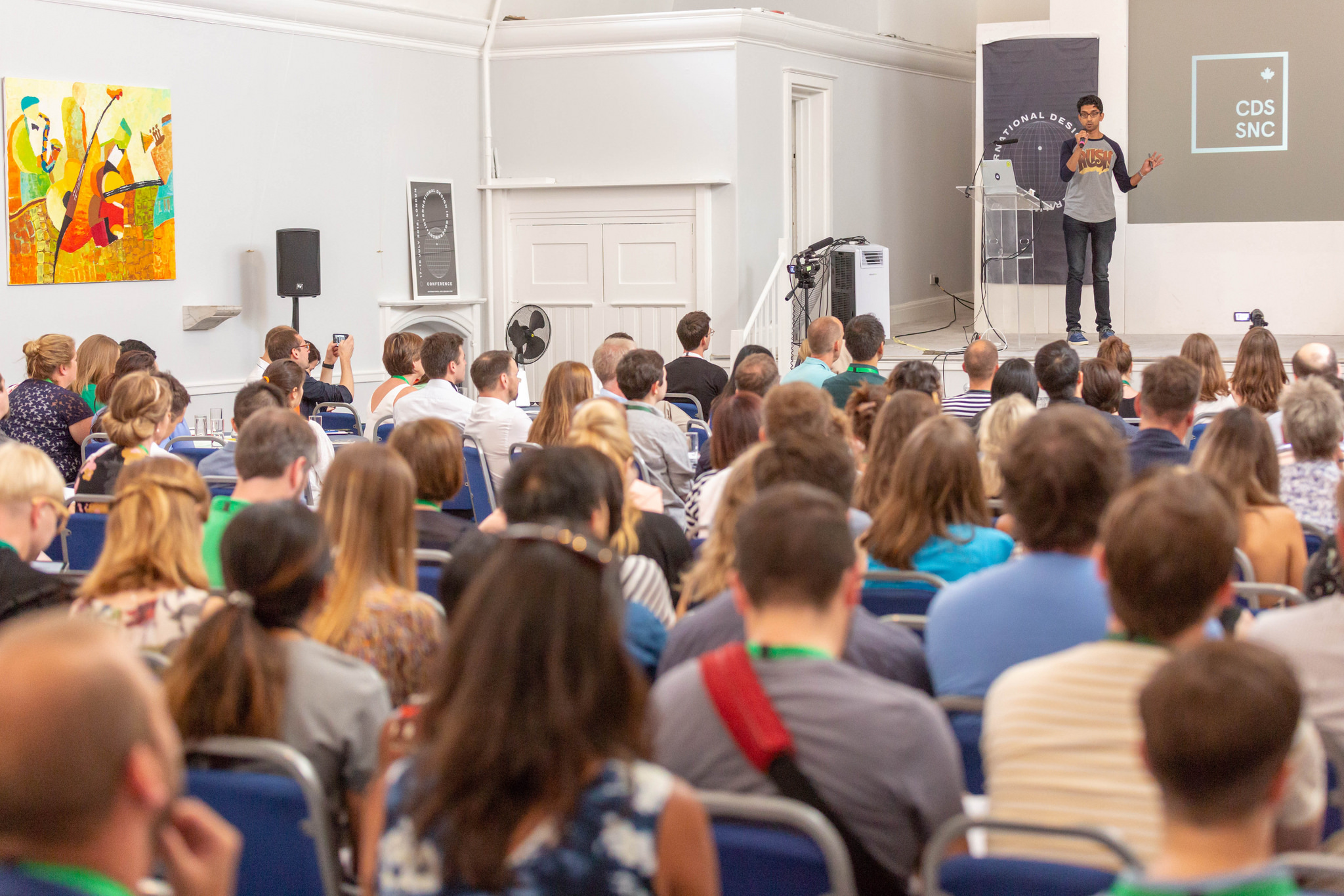 Chris Govias on stage in front of a room full of people