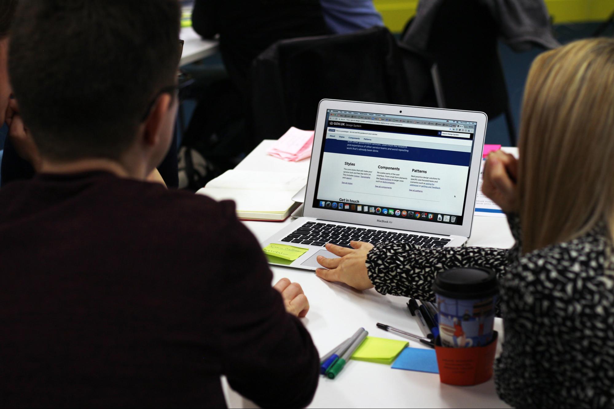 A team of people sitting around a table working on a prototype