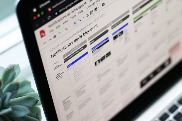 A laptop screen focussing on a section of as-is service blueprint jointly created by the GOV.UK Coronavirus Notifications team