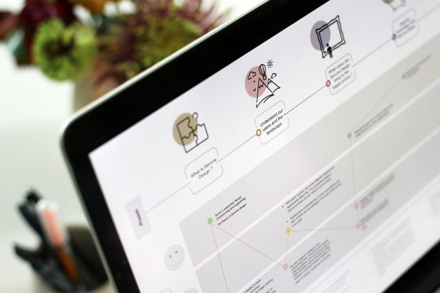 A laptop screen showing a user journey map of service designers at the Department for Education