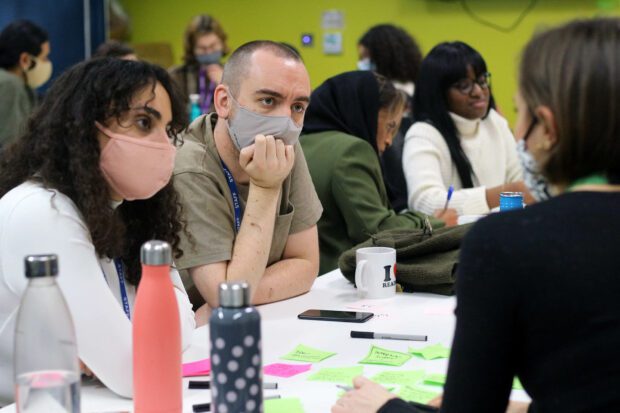 Various GDS designer talking to each other in the London office