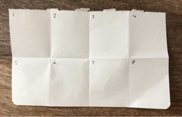 A piece of paper folded three times, then unfolded to show the crease marks, with each square numbered. If you fold a piece of paper once, twice, and once again, you’ll end up with 8 squares with just enough space to sketch (or write) a design idea.