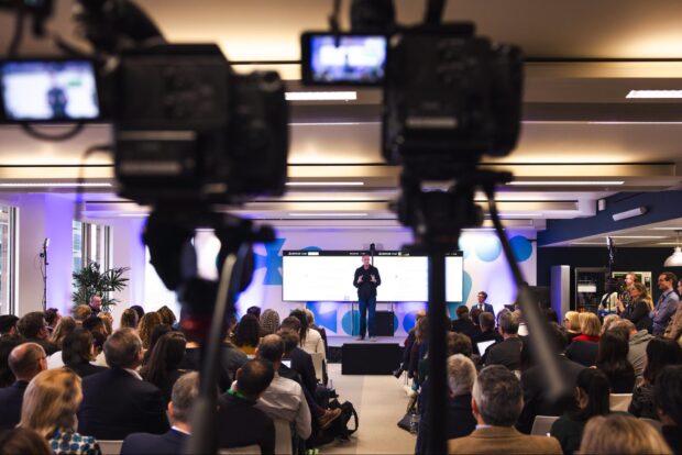 Picture of the audience and Secretary of State Peter Kyle on stage.